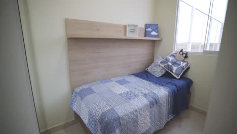slow motion shot of a boy's room with a bed and decorations inside a house