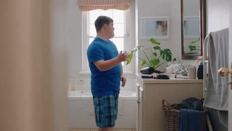 funny-teenage-boy-with-down-syndrome-dancing-in-bathroom-having-fun-doing-silly-dance-moves-enjoying-morning-routine-feeling-happy-at-home