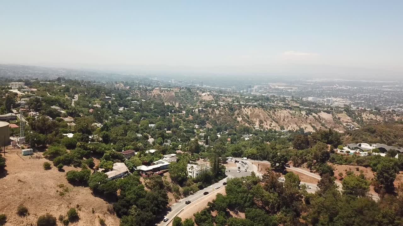 Aerial View of MULHOLLAND DRIVE in Sherman Oaks, California in the San Fernando Valley. Slow Panning Shot During Sunset with Traffic