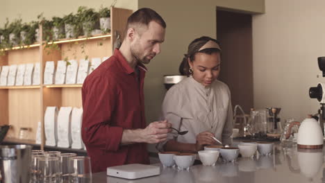 two baristas tasting coffee in cafe