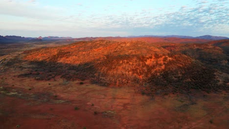 panorama of narrow road between the rocky landscape in the wilderness of alice springs, australia