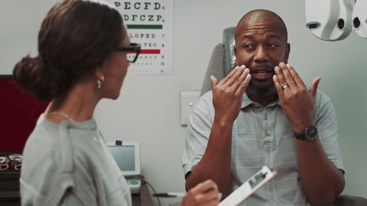 A patient speaking with an optometrist during an eye exam