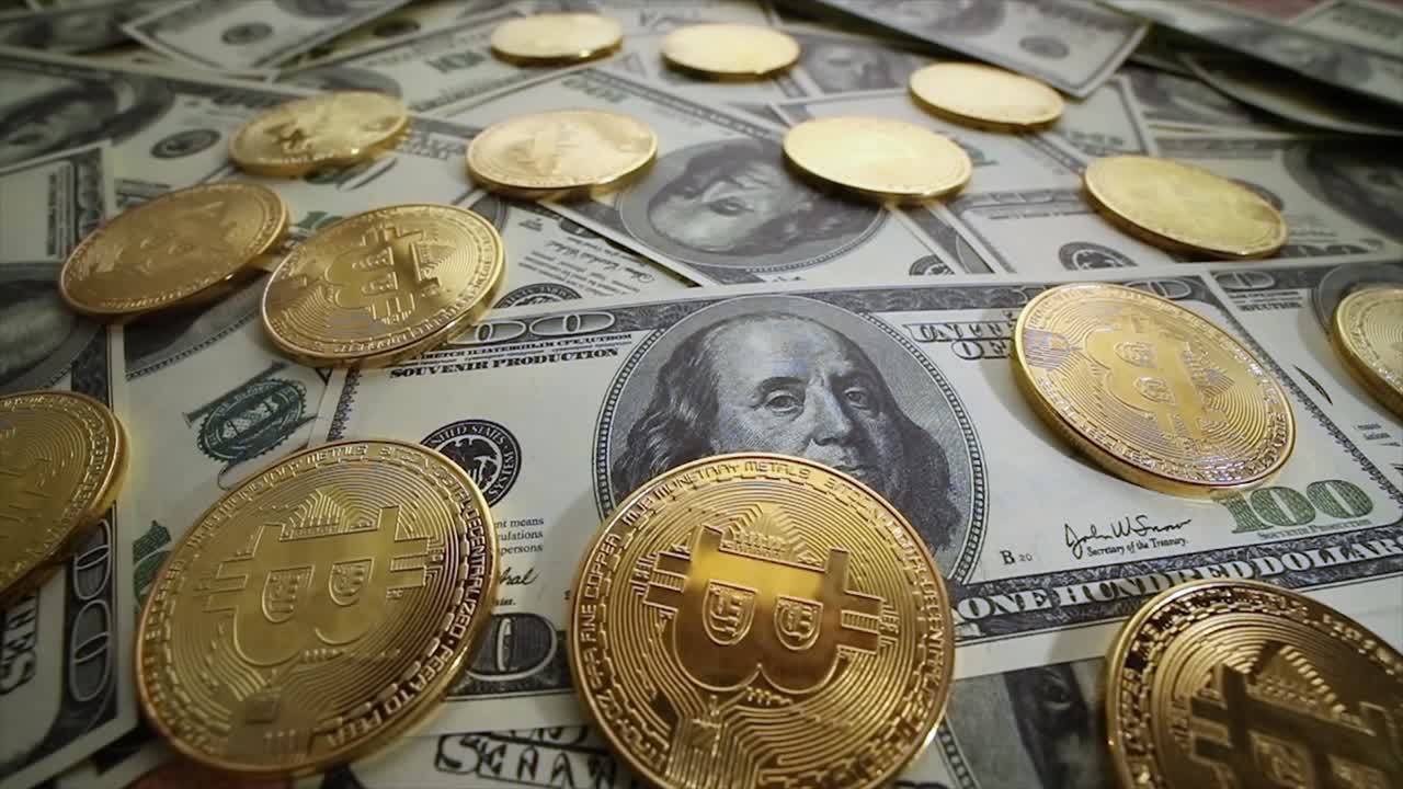 Gold Bit Coin BTC coins and dollar bills.