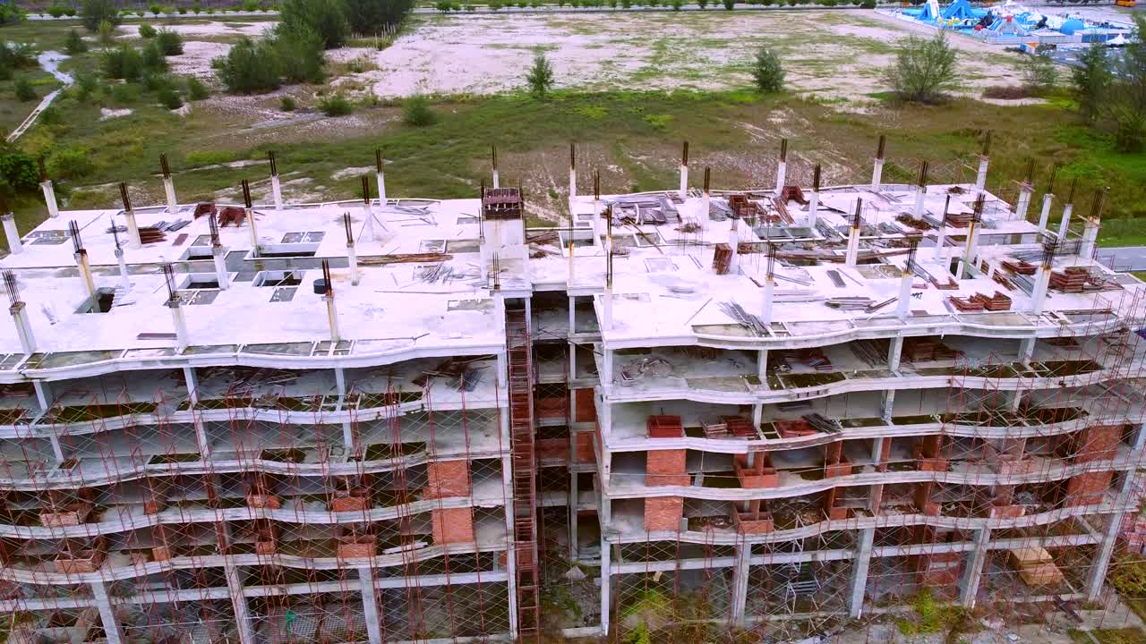 Scaffoldings In Front Of Buildings Under Construction Near The Sea Shore In Malacca, Malaysia - Aerial Shot