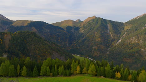 Tyrol-woodland-countryside-aerial-view-rising-to-idyllic-Karwendel-green-alpine-mountains