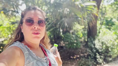 enthusiastic female tourist vlogging experience in sunny athens park