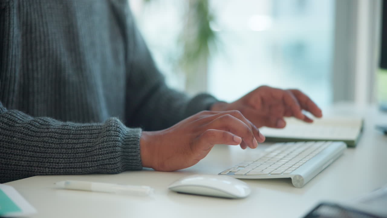 Person's Hands Typing on Keyboard and Using Mouse