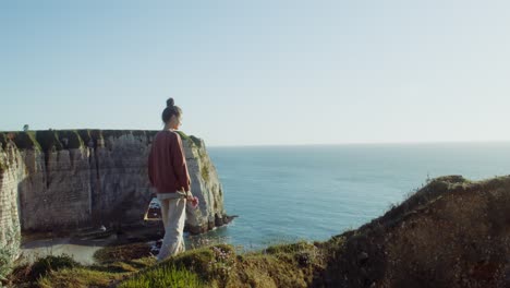 woman at a clifftop ocean viewpoint in france