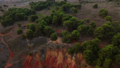 otranto, puglia, italy - a panoramic view of the bauxite cave with its lake surrounded by lush foliage - orbit drone shot