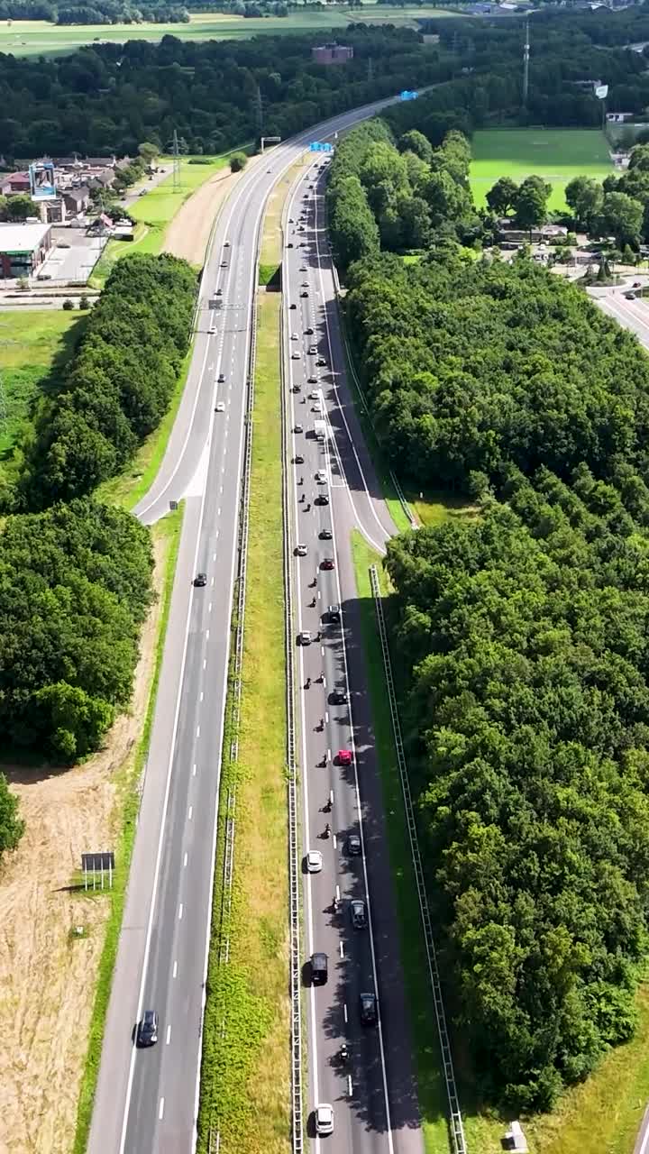 Aerial View of Highway with Traffic and Green Landscape