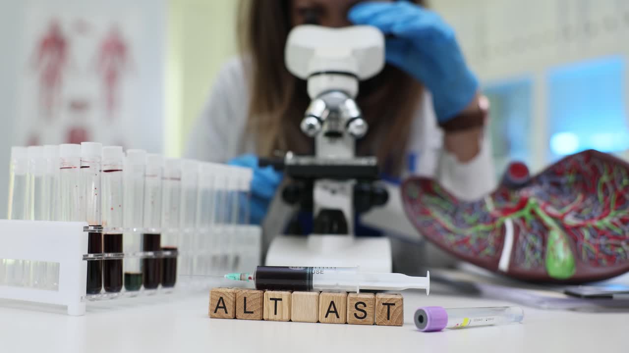 Liver enzyme test setup with microscope and blood samples