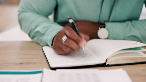 hands, calculator and accountant writing in book