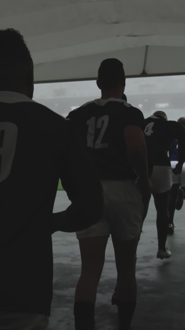 Male rugby players running together in a row at the entrance of stadium 4k