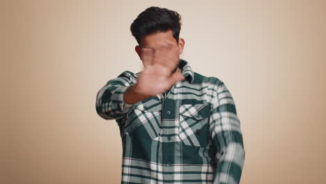 Indian-man-say-No-hold-palm-folded-crossed-hands-in-stop-gesture-warning-of-finish-prohibited-access