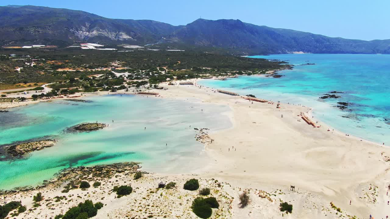 Aerial flying over paradisiac Elafonisi beach towards the island of Crete