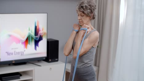 senior woman exercising with resistance bands at home