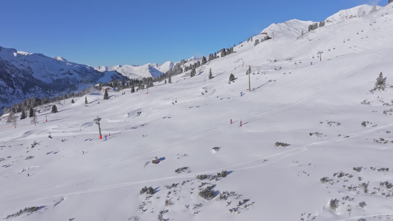 Daytime action on Obertauern packed slopes with skiers and lifts