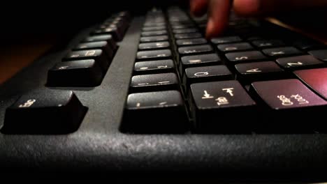 a young child typing in a keyboard of computer