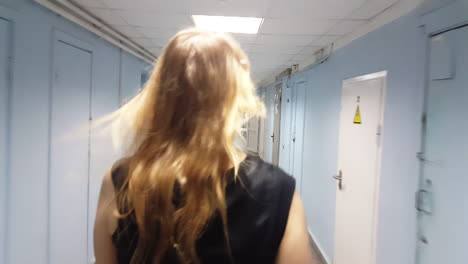 woman walking in empty hallway of the hospital