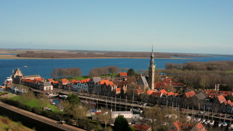 aerial: the historical town of veere with an old harbour and churches, on a spring day