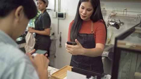 coffee shop owners are taking orders from customers and telling baristas to make menus ordered by customers. lgbt customers are looking at the menu and ordering coffee in coffee shop concept