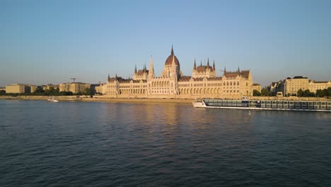 forward drone shot approaches hungarian parliament above danube river