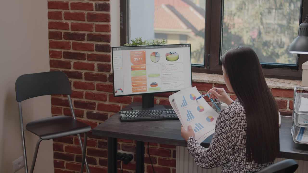 Close up of employee working with charts on papers