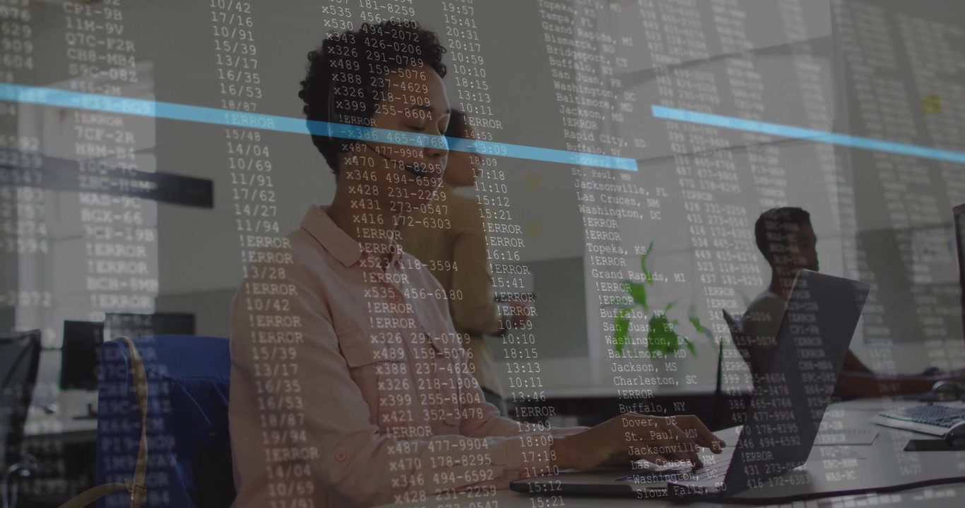 Woman wearing pink shirt typing on laptop in tech office, projecting code overlay across desks
