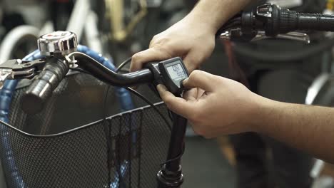 a bicycle mechanic explaining the functionality of a bicycle odometer