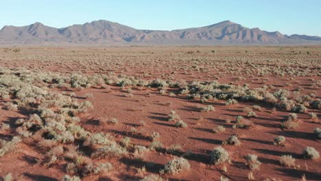 fast drone shot above desert with flinders ranges mountains in background, south australia