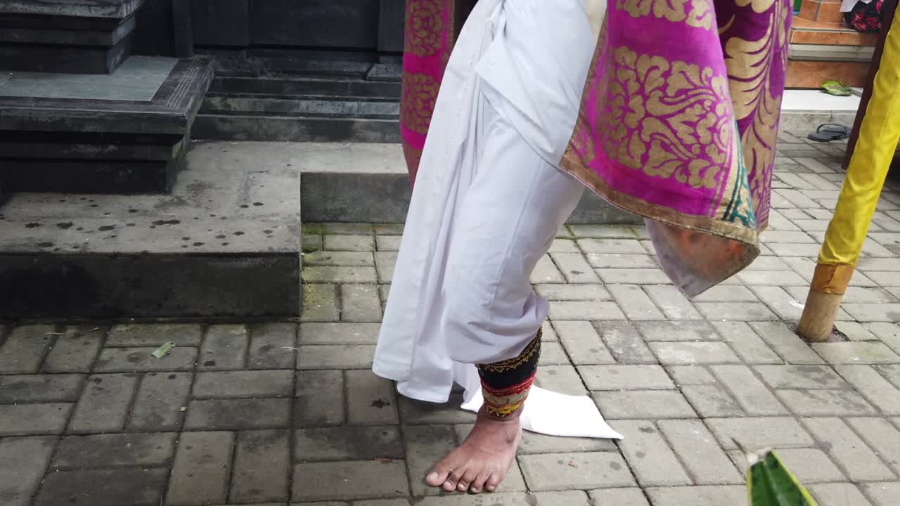 Dancer's Feet Closeup with Colorful Traditional Clothes of Bali Indonesia Topeng Choreography
