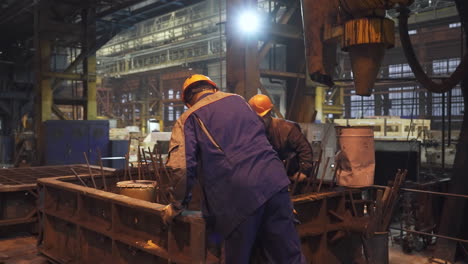 metal casting workers in a factory