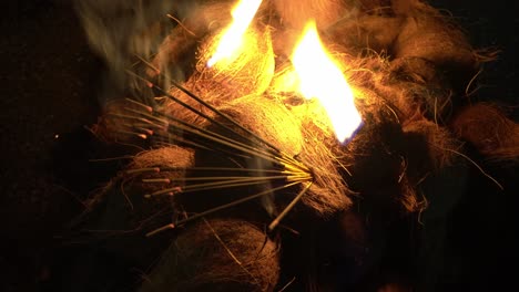 Close-up-shot-of-coconut-with-black-incense-stick