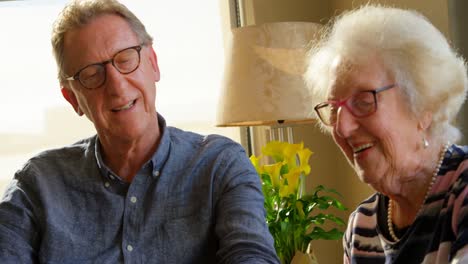 senior couple interacting with each other at dining table 4k