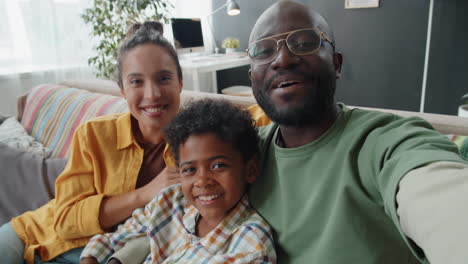 positive african american family chatting on video call at home