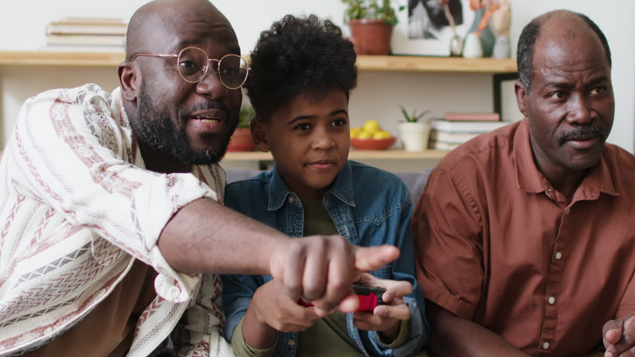 Boy playing video games with family