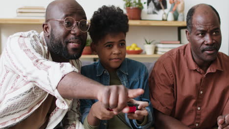 boy playing video games with family