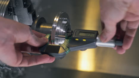 technician makes measures by electrical micrometer