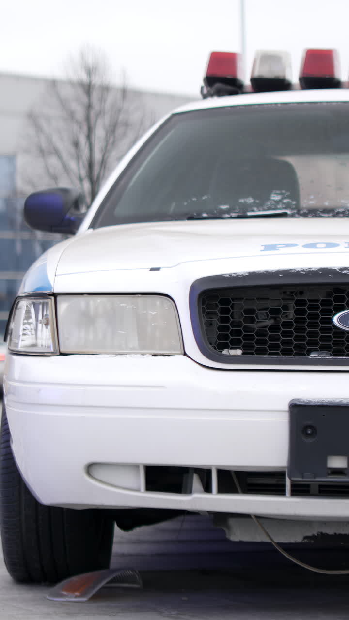 Front View of a White Police Car with Emergency Lights