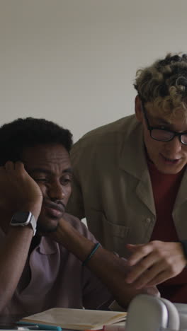 two men collaborating and supporting each other while studying