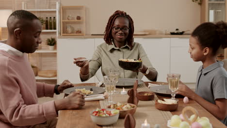 african woman filling plates for family