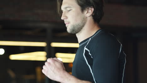 active sport man doing cardio at gym. fit man running on treadmill in sport club