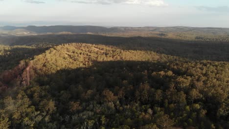 Drone-flight-over-the-Australian-outback-bush,-at-sunset