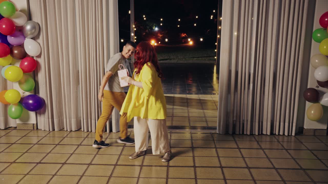 Friends Celebrate at a Party, Exchanging Gifts and Hugs