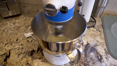 stand mixer whisking dough on the kitchen counter