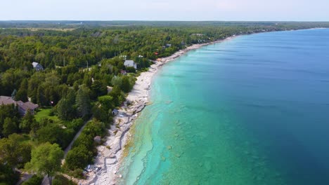 aerial view of a sunny beach with a curved coastline