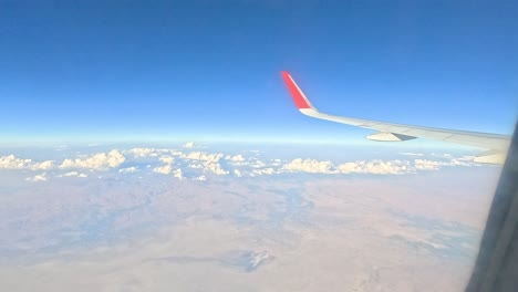 view from airplane window over mountainous terrain