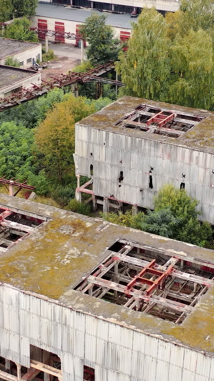 Aerial view of destructive abandoned architecture. Factory destroyed empty buildings. Vertical video