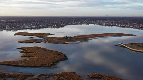An-aerial-shot-over-Baldwin-Bay-near-Freeport,-NY-during-sunset
