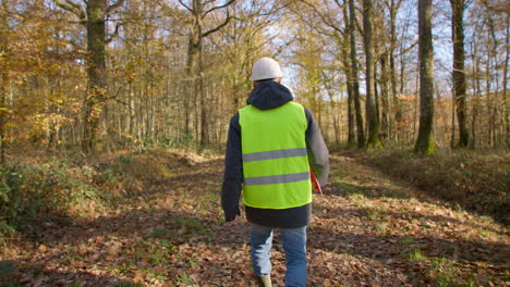 walking through countryside, contractor, high visibility jacket. slow-mo